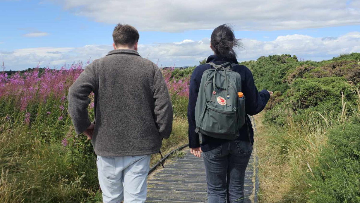 Barbora and a friend seen from behind walking amongst nature